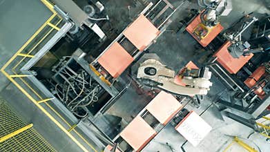 Top view of copper plates getting processed by automated machines