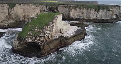 Shark Fin Cove Beach with a Towering rock and Sea Cave. California. Pacific  Ocean Waves. Island. Drone 3