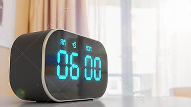 Close-up digital alarm clock against window in the hotel room win sun flare