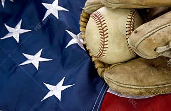 Major league baseball with American flag and glove