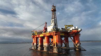 Oil and Gas Rigs Seen up Close at Sunset