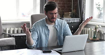 Nervous male freelancer analyze business papers troubled with financial problem