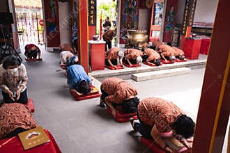 The congregation and the visitors have a prostration while praying in the temple