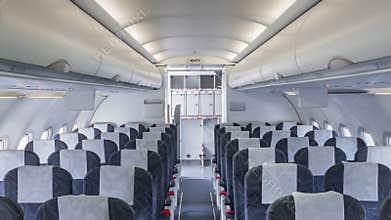 Airplane cabin and aisle with empty seats gradually absorbed by mysterious white light
