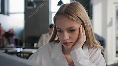 Close-up young caucasian upset girl student sitting alone in classroom at desk suffering from abuse ridicule bad