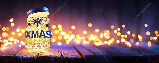 Christmas Light In Decorative Jar On wooden Table