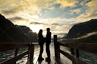 Couple silhouette at mountain lake
