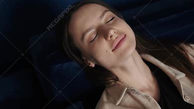 Close up Portrait of relaxed smiling woman sleeping in bed at home. Portrait of young Caucasian woman resting at home