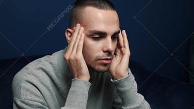 Depressed desperate man feeling worried . Stressed businessman looking frustrated sitting at home