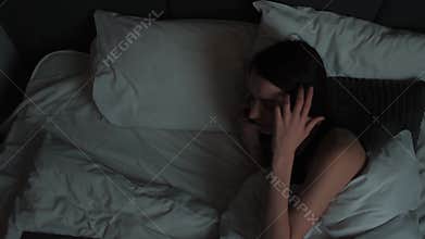 Caucasian young woman she wake up when smartphone calling