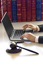 Lawyer woman`s hands with judicial gavel during online consultation with client.