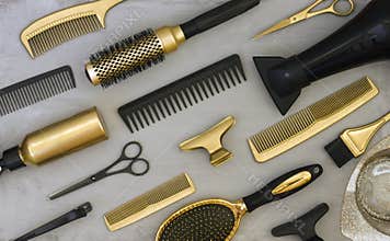 Background with gold and black hair salon accessories.
