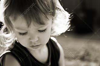 Cute little girl in the rays of sun