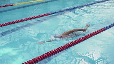 Handsome athlete swimmer sportsman training in swimming pool