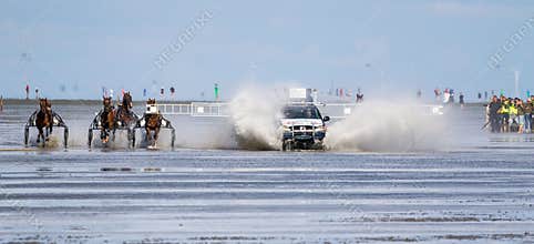 Cuxhaven, Germany - Aug 25, 2019: equestrian at the horse race in the mud flat at Duhner Wattrennen