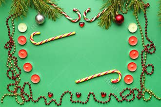 Christmas frames with candies, candles and pine sprigs with toys on a green background.