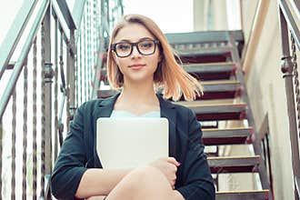 Business Woman girl student sitting on stairs on a coffee break, well disposed outside business office building school university