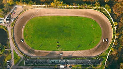 Aerial view on top Races on the racetrack. Cars driving in a circle drifting around corners compete for first place in
