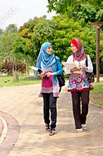 Muslim woman carrying books