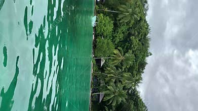 Lagoon With Huts On Ocean Beach In Kaimana Island. Vertical Video Of Turquoise Sea And Picturesque Tropical Resort With Bungalows