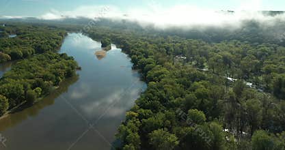 Clouds and a fog bank obscure the hills along the Wisconsin River during an autumn morning near Prairie du Chien