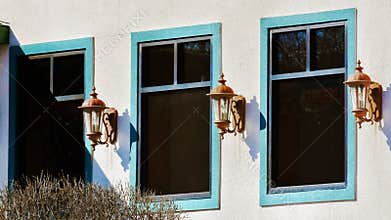 Three teal Windows and Three Lanterns