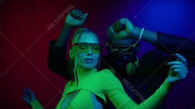 Beautiful girl in the disco club. Pretty girl moving in neon light on black background. Beautiful girl dancing in