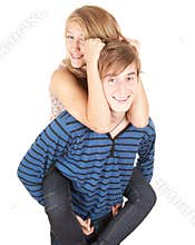 Happy boyfriend giving girl a piggyback