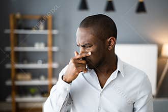 Man Covering His Nose From Bad Smell