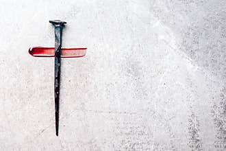 Christian cross made with rusty nails, drops of blood on grey background. Copy space. Good Friday, Easter day. Christian