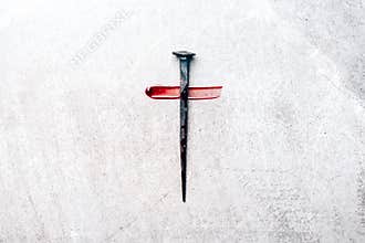 Christian cross made with rusty nails, drops of blood on grey background. Copy space. Good Friday, Easter day. Christian