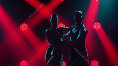 Graceful Argentine tango among smoke and bright red neon lights in a dark studio. Dance show performed by passionate