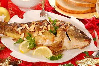 Carp baked with almonds for christmas