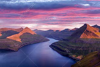 Incredible purple sunset over majestic fjords of Funningur