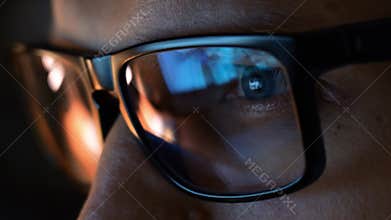 Close up view of focused businessman wear computer glasses looking at pc screen.
