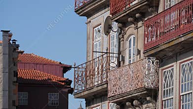 Facades of old buildings with vintage lattice on balconies. Streets and houses of Porto, Portugal.
