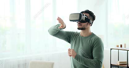 Man wearing vr headset and operating virtual screen