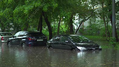 Flooded cars on the street of the city. Street after heavy rain. Water could enter the engine, transmission parts or other places