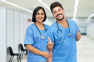 Laughing latin american male and female nurses at vaccination station