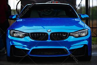 Blue BMW M4 F83 wrapped in blue chrome wrap vinyl on Drift And Car Show. Luxury German vehicle with led