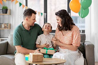 parents giving birthday present to little son