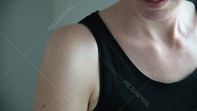 Woman using a body hair removal tool machine on her armpit