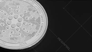 Cryptocurrency - cardano coin rotates. View from above.