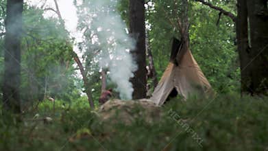 bonfire firing of ceramics of North American Indians in an ancient way. On the background of the tipi, the portable