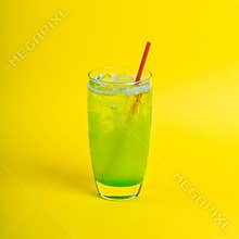 green fresh cocktail smoothie jusice in glass with ice on yellow background. vitamin drink detox