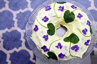Delicious Lemony Cake Frosted with Violet Flowers - Horizontal