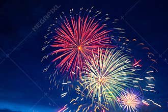 Fireworks on the background of the cloudy night sky. 4th of July - American Independence Day USA