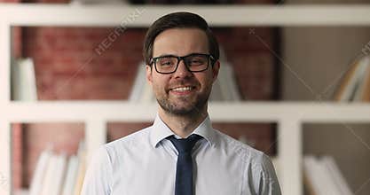 Happy friendly young male ceo executive manager looking at camera.