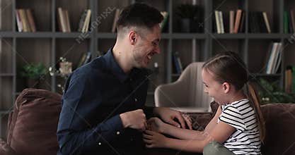 Emotional happy young father cuddling little daughter.