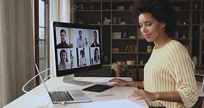 Black lady meet multiethnic teammates in conference app on desktop